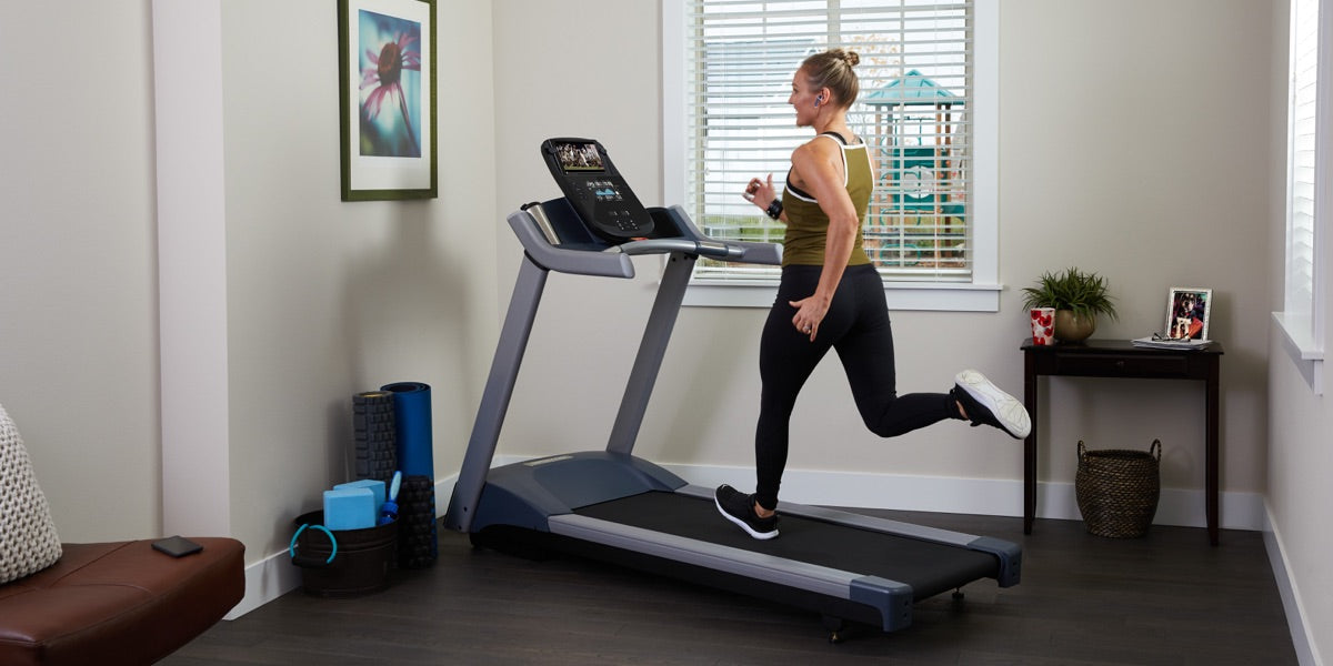 Man running on a Precor TRM 731 interval professional treadmill with Integrated Footplant Technology