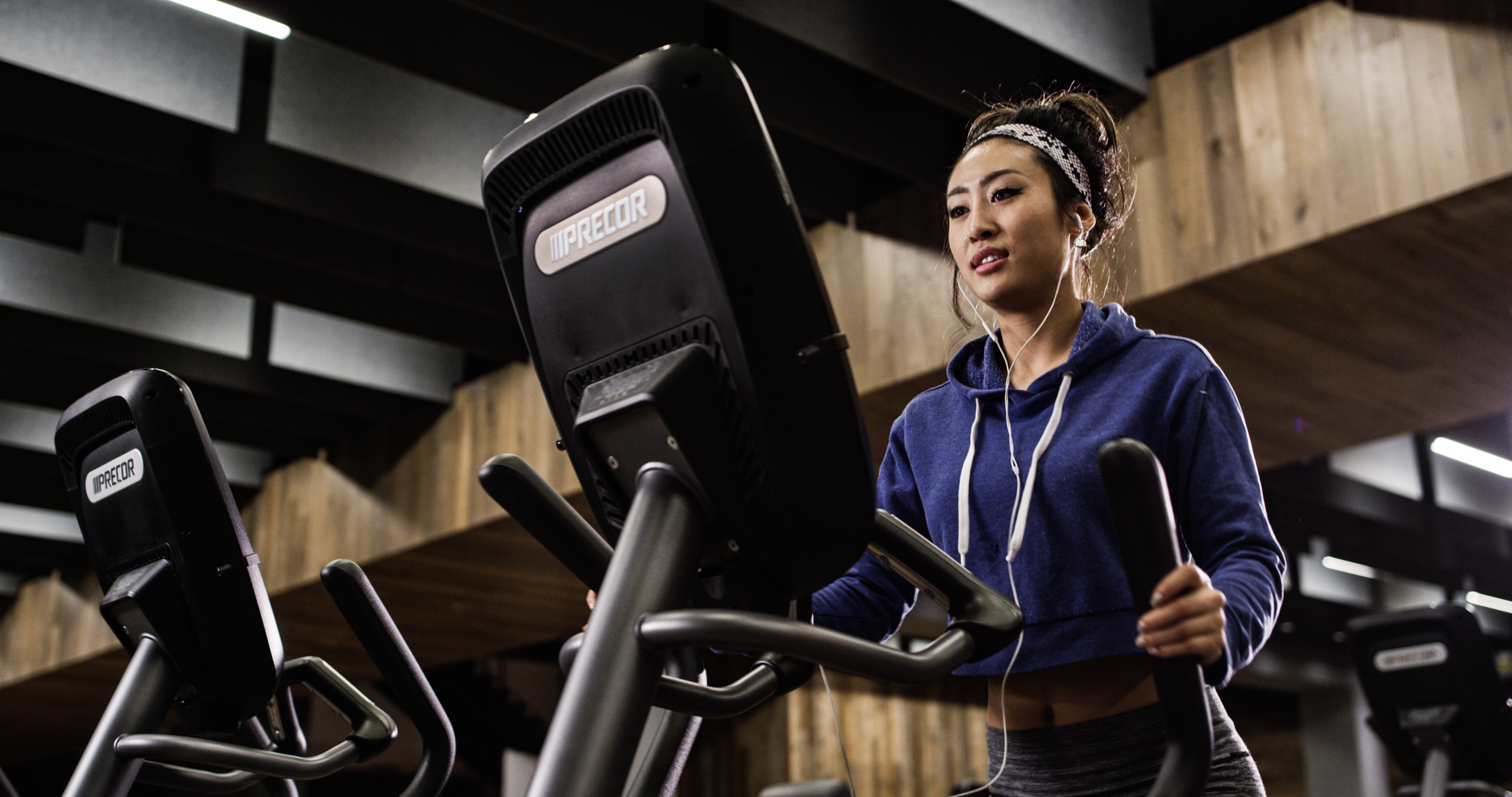 Virtual Tour of Precor - woman working out in a fitness facility on a Precor elliptical EFX 885