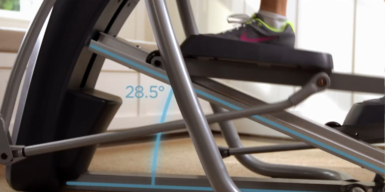 Close up of a Precor elliptical machine in use featuring its 28.5-degree adjustable incline