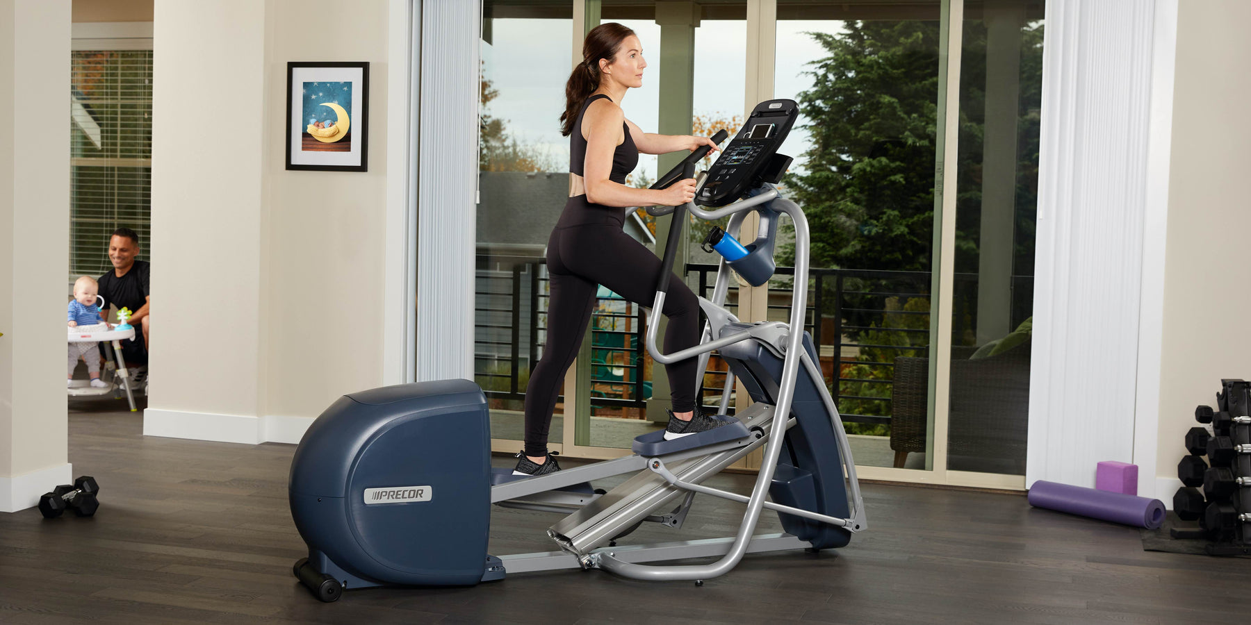 female exerciser cardio workout on Precor EFX 400 Line elliptical at home